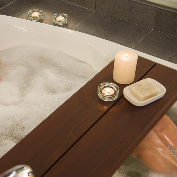 Invisia Bath Bench with candles and soap sitting on it to show how relaxing and safe baths are possible