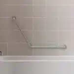 120° grab bar on a tile wall in a bath/shower combo.