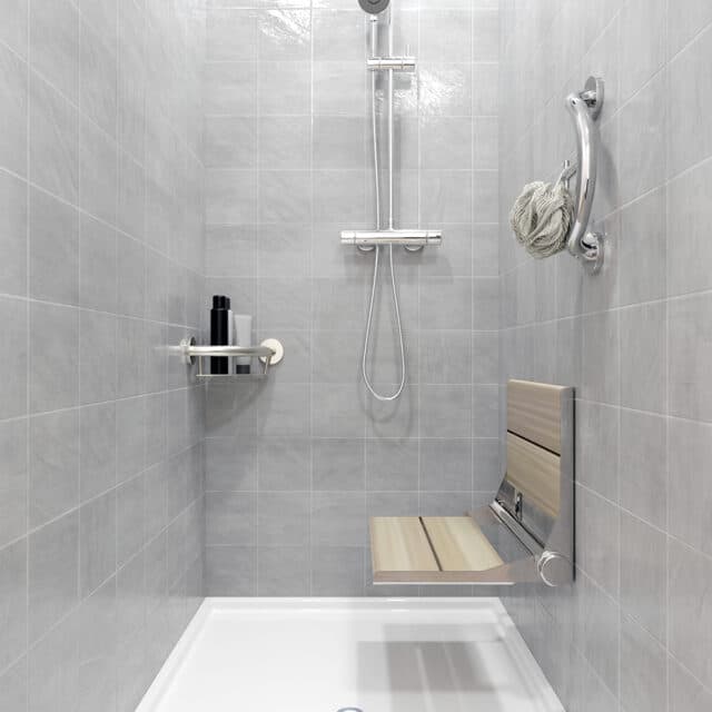 Support accessories and light wood seat in a tiled shower.